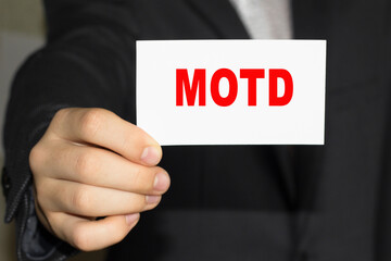 Card with text MOTD on hand. You can use in business, marketing and other concepts. Messege of the day