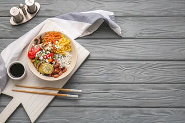 Plate of delicious rice salad with vegetables on dark wooden background