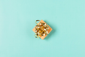 Top view gift box with gold bow and ribbons