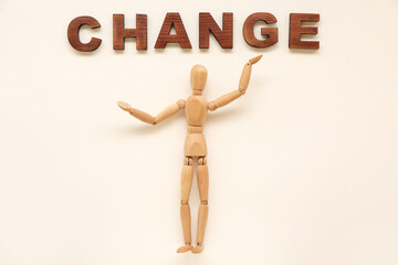 Wooden mannequin with word CHANGE on white background