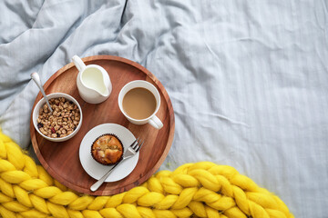 Tray with tasty breakfast on bed, top view