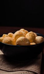 Homemade cheese buns, rustic style, vintage wooden background, top view. typical food from minas gerais Brazil.