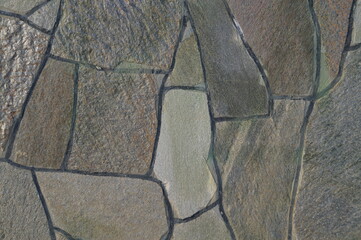 Close-up (macro photography) of a stone wall (stone mosaic). Natural light. Can be used as...