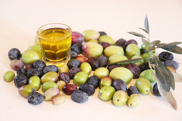 Olive oil with olives on white background. Freashly gathered, raw and organic.