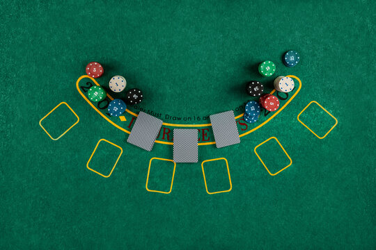Chips cards lie on a green blackjack table top view. Casino concept, gambling.