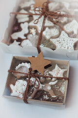 Christmas homemade gingerbread cookies on white background. New Year's gift in a box.