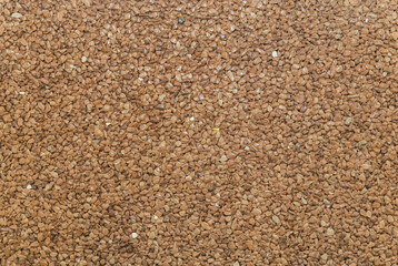 brown pavement lined with tiny round pebbles 
