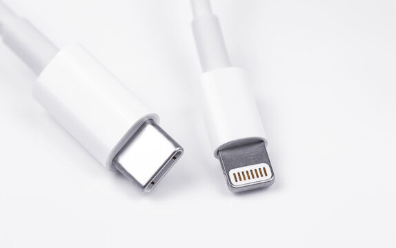Apple Lightning to USB-C cable on the white background, macro. Apple is a multinational technology company. Moscow, Russia - September 15, 2020