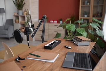 Background image of home recording studio with music equipment and laptop on desk, copy space