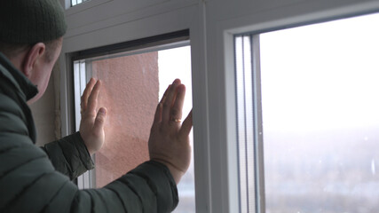 Windows installation worker, construction worker sets of plastic window. Close up of hand