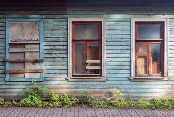 Fototapeta na wymiar Three interesting Windows in a blue wooden old wall