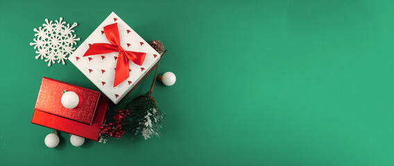 Minimalistic gift wrapping concept on green background, christmas banner with copy space