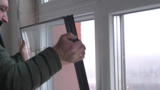 Windows installation worker, construction worker sets of plastic window. Close up of hand