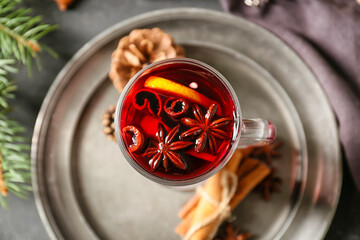 Glass cup of tasty mulled wine on table, closeup