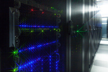 Network servers in a data center. Tier III carrier neutral data center. Server rooms.