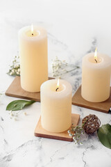 Beautiful aroma candles on light background