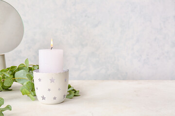 Beautiful aroma candle on table in bathroom