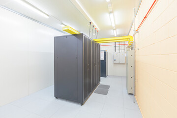 Network servers in a data center. Tier III carrier neutral data center. Server rooms.