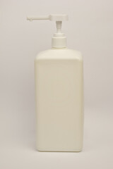 White plastic container for liquid with a dispenser on a white background with clipping