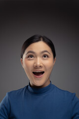 Close up shot of happy Asian woman look up with copy space.