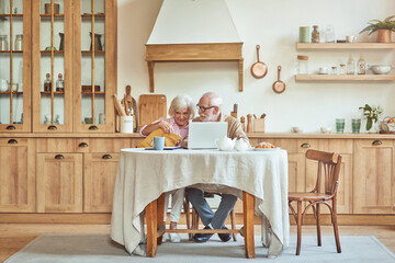Happy elderly woman holding envelope with documents and sitting hear her husband