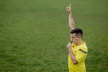 Referee indicates a violation of the rules. Concept of sport, rules violation, offside. © volody10