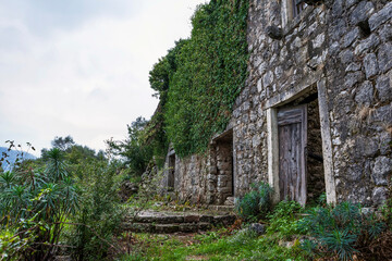 Fototapeta na wymiar Ruined house in Gornji Stoliv, a largely abandoned village high above the Bay of Kotor, Montenegro