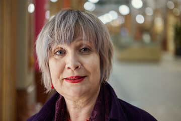 Portrait of mature beautiful smiling woman in shopping mall.