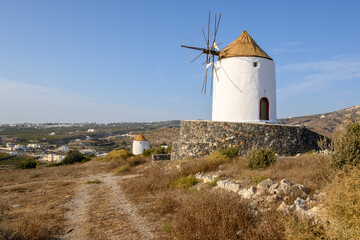 Fototapeta na wymiar Old windmill in Emporio village on the south side of Santorni. Cyclades Islands, Greece