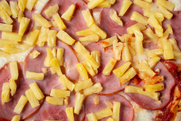 A top down view of a Hawaiian pizza as a background.