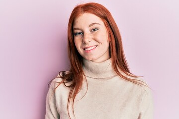 Obraz premium Young red head girl wearing turtleneck sweater with a happy and cool smile on face. lucky person.
