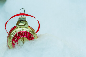 Retro clock Christmas toy in the snow