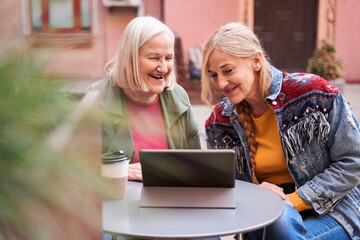 Woman and her daughter using digital tablet