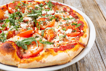 A view of a rustic Margherita pizza pie.