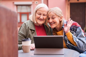 Woman and her lovely daughter using tablet