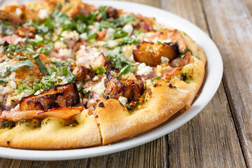 A view of an eggplant and ham pizza pie.