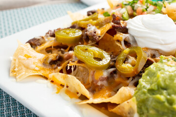 A closeup view of a plate of nachos.