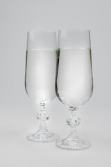 two glasses with champagne on a white background
