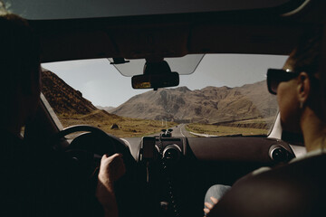 couple driving car view from car interior to mountains auto trip. High quality photo