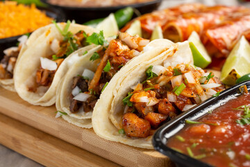 A closeup view of several street tacos on a food platter.