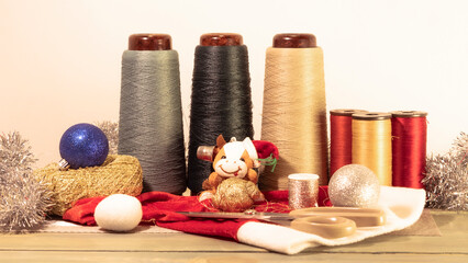 Fototapeta na wymiar set of threads and balls for needlework and new year's cow