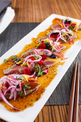 A view of a plate of tuna carpaccio.