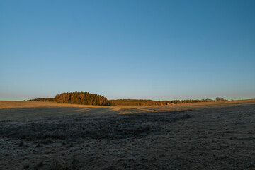 Rybnik village with pasture land in frosty color morning in sunrise time