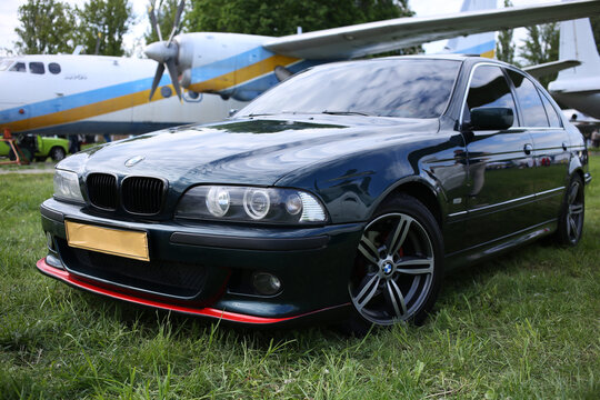 Powerful, sporty, black BMW E39 520i at an exhibition at the airport.