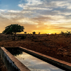 sunset over water with landscape