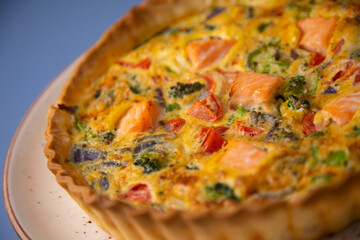 Traditional salmon quiche with broccoli and vegetables