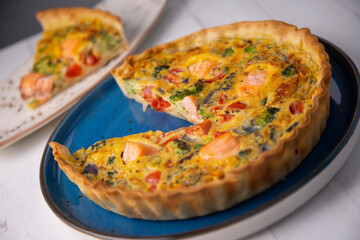 Traditional salmon quiche with broccoli and vegetables