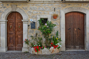 Fototapeta na wymiar The door of an old house in Scontrone, a medieval village in the Abruzzo region, Italy.
