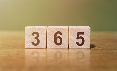 365 word written on wooden blocks on wooden table. New Days 365 New Chances