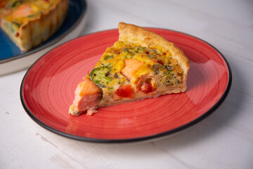 Traditional salmon quiche with broccoli and vegetables